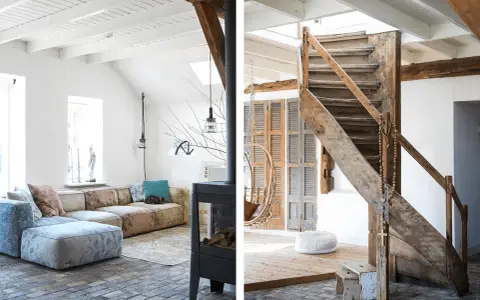 Ambiance chaleureuse dans cet **intérieur ferme rénovée moderne**. Canapé modulable, poêle design et escalier rustique en bois.
