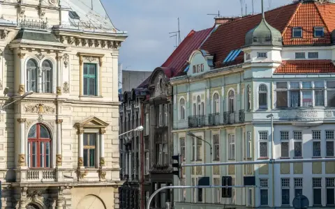 Kamienice na rynku w Bielsku-Białej, z bogatymi zdobieniami i różnorodnymi dachami, tworzą malowniczy widok.