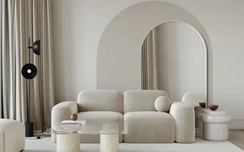 Nowoczesny salon z beżową kanapą, łukiem nad lustrem i stolikiem kawowym. Inspiracja, jak zrobić łuk w aranżacji wnętrz.