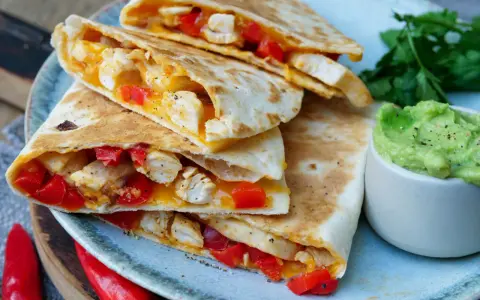 Leckere Quesadillas mit Hähnchen, Paprika und Käse, dazu Guacamole. Ein tolles Quesadillas Rezept für jeden Anlass.