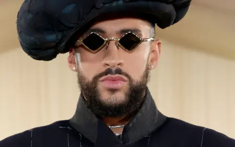 Bad Bunny at the Met Gala, sporting diamond-shaped sunglasses and a dramatic black hat.