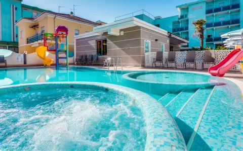 Piscine scintillanti e scivoli colorati in un adriatico family village, perfetti per il divertimento di tutta la famiglia.