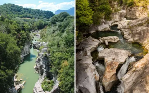 Gole scavate dall'acqua tra le verdi marche montagna. Un fiume serpeggia tra rocce levigate e vegetazione lussureggiante.