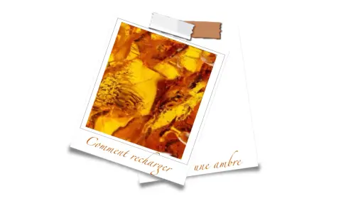 Gros plan sur une pièce d'ambre aux reflets dorés et orangés, sur fond blanc.
