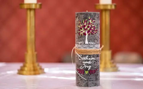 Eine liebevoll gestaltete Hochzeitskerze mit Baum, Namen und Herz. Ein schönes Symbol für die Liebe.