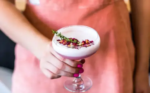 Elegancki koktajl z Gordon's gin, pianką, płatkami róż i gałązką tymianku. Idealny na letnie wieczory.