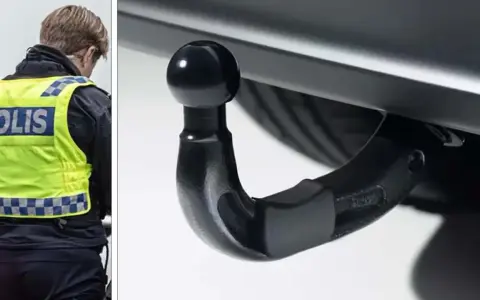 Polis med reflexväst inspekterar dragkrok, en viktig del av husvagns kollen för säker färd.