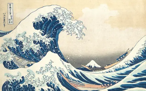 A massive blue wave crests, threatening boats below. In the distance, Mount Fuji, a peak from the "Thirty-six Views of Mount Fuji" series, stands serene.