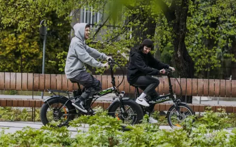 Dwie osoby cieszą się jazdą na rowerach elektrycznych. Dofinansowanie do roweru elektrycznego sprawia, że takie wycieczki są dostępne dla każdego.