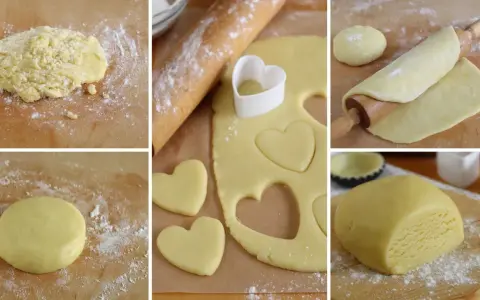 Preparazione di biscotti pasta frolla a forma di cuore. L'impasto viene steso e tagliato con un coppapasta.
