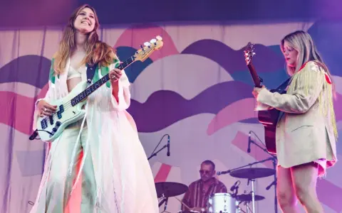 Kvinnlig basist och gitarrist uppträder på en konsert. Bakom dem sitter en trummis. En **first aid kit konsert** kan vara bra att ha nära till hands.
