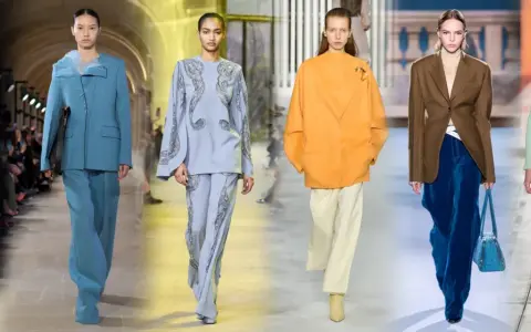 Modelli sfilano con eleganti completi pantalone, un'idea chic per come vestirsi ad un matrimonio con pantaloni.