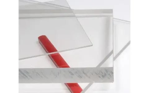 Clear acrylic sheets with a red rod on a white background.