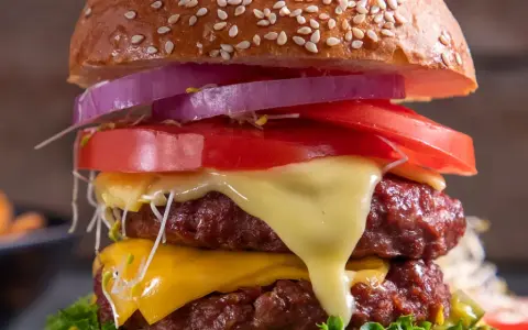 Burger domowy kontra cheeseburger z sieciówki. Podwójna wołowina, ser, pomidor, cebula i kiełki w domowym wydaniu.