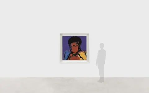 Andy Warhol's iconic portrait of Muhammad Ali, rendered in bold colors, captures the boxer's powerful stance.
