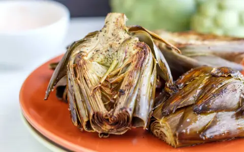 Alcachofas al horno, doradas y tiernas, listas para disfrutar. Un plato sencillo y delicioso.