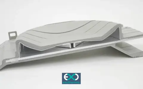 A complex, layered component showcasing advanced forming plastics, with a subtle wave pattern on the top surface.
