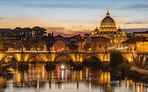 Zachód słońca nad Rzymem, z bazyliką św. Piotra i Ponte Sant'Angelo. Czy lecąc do Rzymu potrzebny jest paszport? Tak, jeśli podróżujesz spoza strefy Schengen.