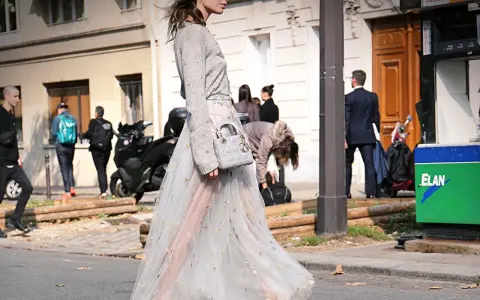 Elegante outfit vestido invierno con falda de tul bordada y jersey gris. Bolso Dior y zapatos de tacón completan el look.