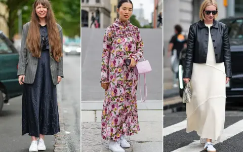 Tre donne con abiti lunghi e sneakers bianche: una con blazer grigio, una con abito floreale rosa, l'altra con giacca in pelle nera.