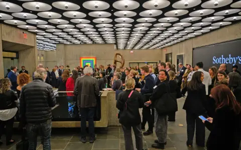 A crowd gathers at a Sotheby's event, a vibrant scene in the contemporary art market.
