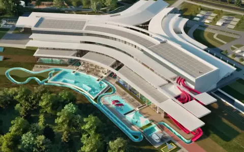 Nowoczesny aquapark Rzeszów z basenami, zjeżdżalniami i strefą relaksu, otoczony zielenią.
