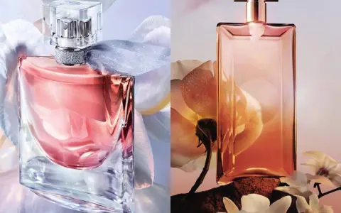 Dwa flakony perfum: różowy "La Vie Est Belle" otoczony białymi kwiatami i pomarańczowy "Idôle" na tle kwiatów i skał.