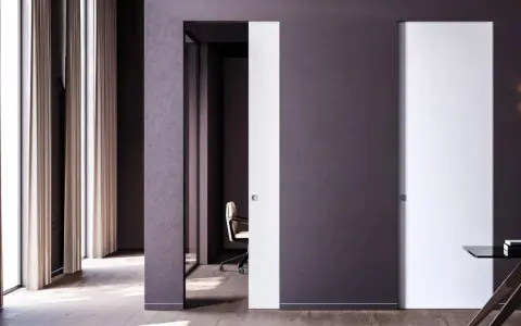 Paredes blancas y puertas de color blanco y morado oscuro, con una silla de oficina y un escritorio.