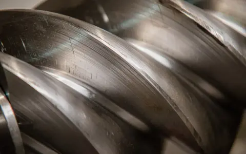Metalowe śruby kompresora, tworzące przestrzeń do wytworzenia podciśnienia a próżni.