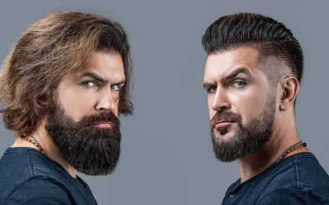Dos hombres con barba. Uno con pelo largo y barba tupida, el otro con pelo corto y barba hipster corta.