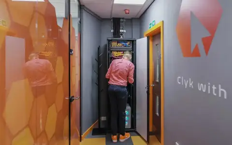 Technician working on network infrastructure services in a server room.