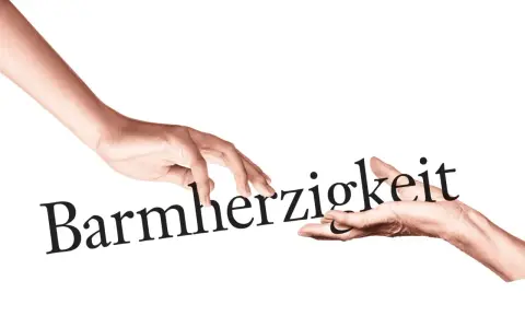 Zwei Hände berühren das Wort "Barmherzigkeit". Eine Hand reicht es der anderen, ein Symbol für die Werke der Barmherzigkeit.