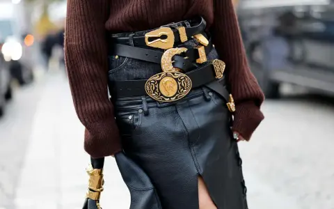 Layered black belts with ornate gold buckles make a bold statement, proving belts are definitely in style.