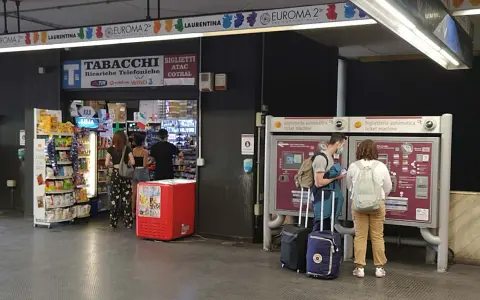 Na dworcu w Rzymie Ciampino ludzie kupują bilety i artykuły w sklepie.