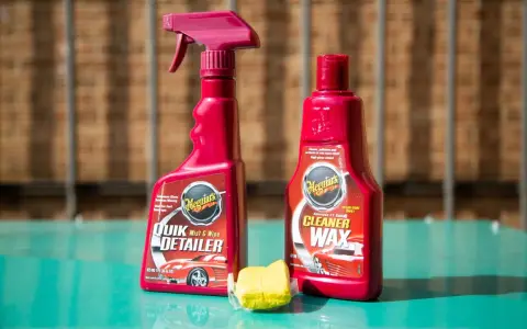 Car detailing supplies: Meguiar's Quik Detailer, Cleaner Wax, and a clay bar for a smooth finish.