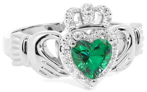 Anello Claddagh con cuore verde smeraldo, circondato da diamanti e sormontato da una corona scintillante.