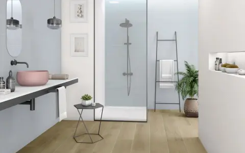 Nowoczesna, biała łazienka z drewnianą podłogą, prysznicem walk-in i różową umywalką.