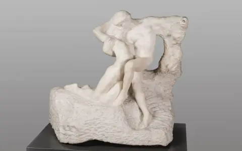 A marble sculpture of two embracing figures, a man lifting a woman, evoking Rodin's eternal spring of love and passion.