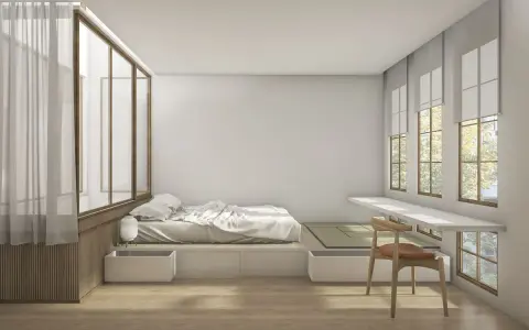 Camera da letto minimalista con letto feng shui, tatami, scrivania a muro e grandi finestre con vista su alberi.