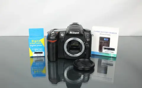 Nikon D80 z akcesoriami: ładowarka i bateria do aparatu cyfrowego.