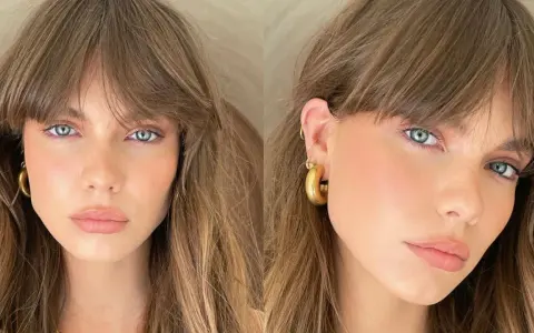 Mujer con ojos azules y cabello castaño, luciendo un "no makeup makeup look" con mejillas sonrosadas y labios naturales.