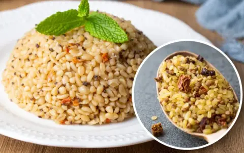 Kasza bulgur na talerzu, ozdobiona miętą. W zbliżeniu łyżka pełna kaszy z dodatkami. Odkryj jej zdrowe właściwości!