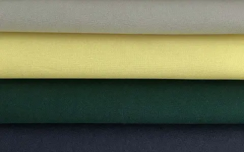 Stacked swatches of poplin fabric in white, light grey, yellow, dark green, and navy blue.