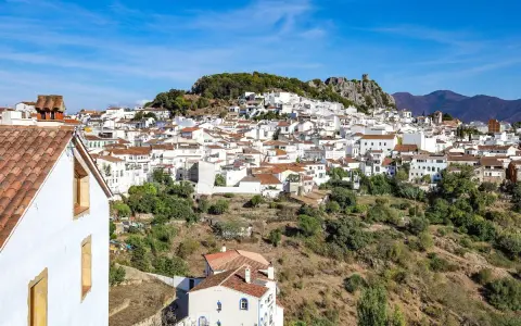 A picturesque white village cascades down a hillside, perfect for a southern Spain itinerary.