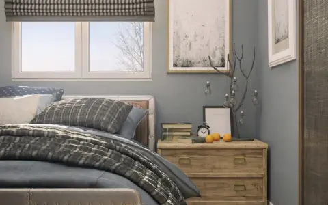 Ideas para decorar una habitación: cama con textiles grises, mesita de noche de madera con adornos y cuadros en la pared.