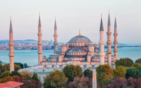 Błękitny Meczet w Stambule, z minaretami górującymi nad miastem i morzem. Czy Istambuł jest bezpieczny? Turyści spacerują pośród pięknej architektury.