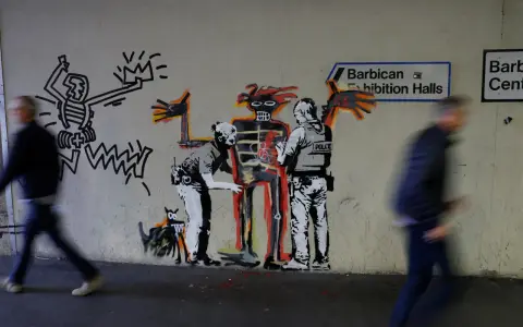 Famous graffiti depicts two police officers interacting with a skeletal figure, with a Keith Haring-esque character and a dog nearby.