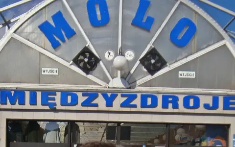 Napis "MOLO" i "MIĘDZYDROJE" na budynku, który może być częścią Alei Gwiazd w Międzyzdrojach.