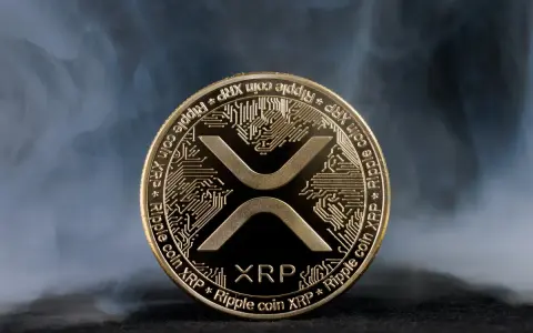 Złoty token kryptowaluty XRP, otoczony mgłą, symbolizuje przyszłość finansów.