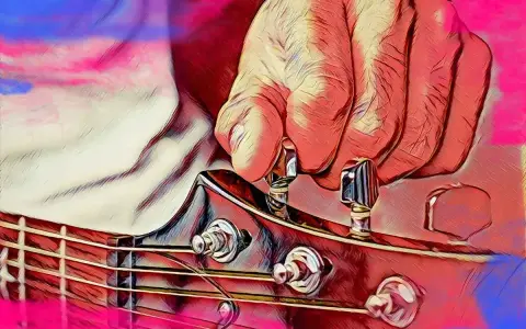 Dłoń stroi gitarę, naciągając struny do idealnego dźwięku a 440 hz.